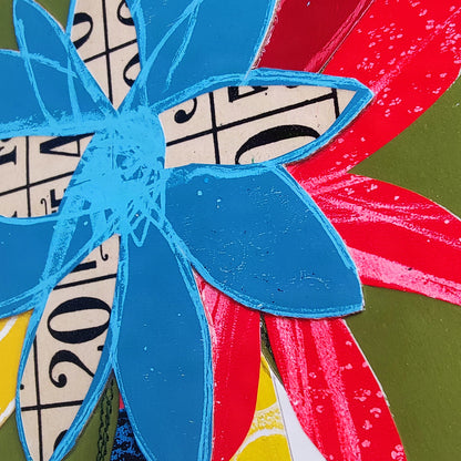 A close-up of a colorful abstract floral artwork with layered flower shapes.