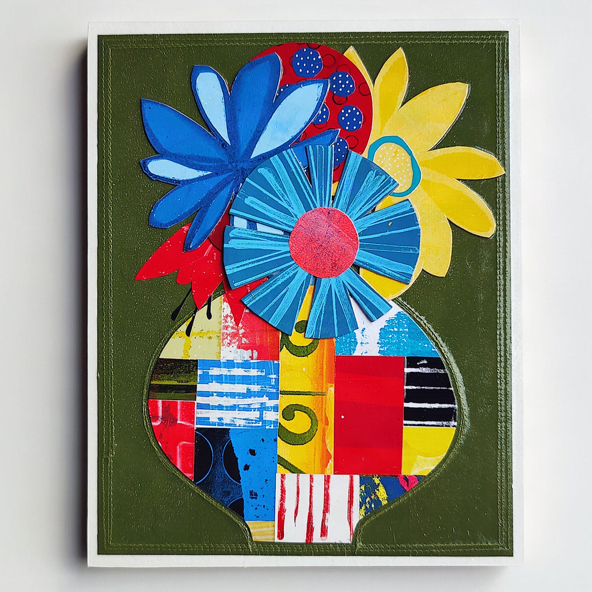 Abstract floral artwork featuring large stylized flowers in blue, yellow, red, and light blue arranged above a patchwork-like vase shape on an olive green background.